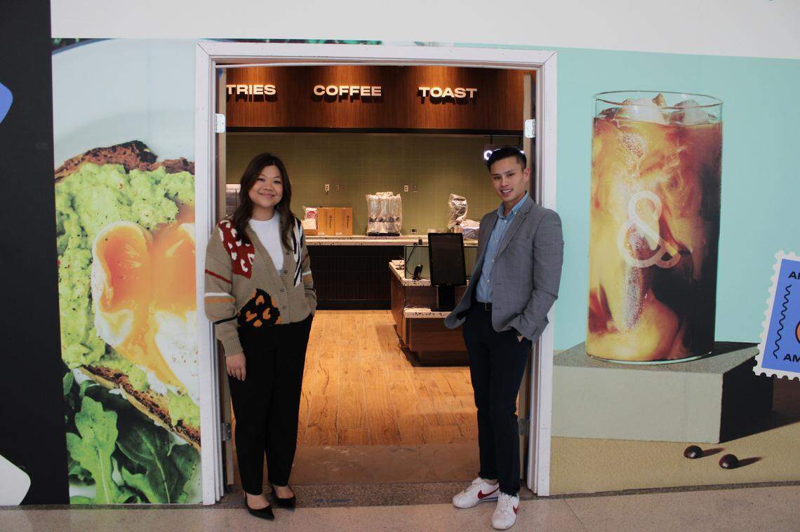 Mimi Lu, left, and Toan Luong, right, the owners of Ampersand, stand outside of their $2 million DFW Airport coffee shop.