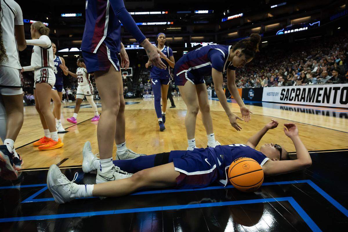 Texas Christian University Horned Frogs lays on ground after fouled during the NCAA Women’s Basketball Tournament Elite 8 at Golden 1 Center in Sacramento on Monday.