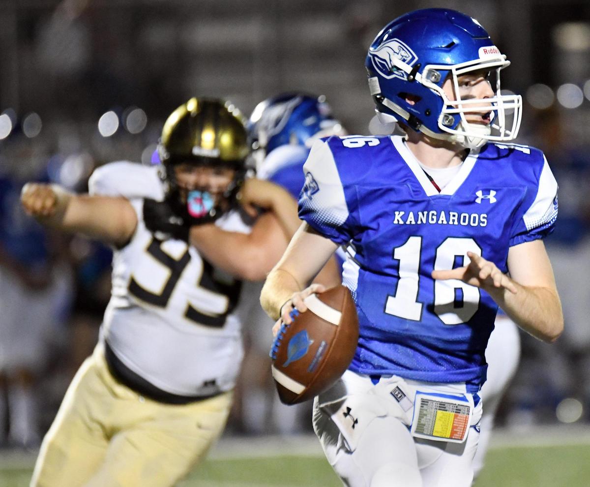 Cleburne’s Jose Chavez, left tries to pursue Weatherford quarterback Major Youngblood as he looks for the open receiver in the second quarter of their football game Friday, October 9, 2020 at Kangaroo Stadium in Weatherford, Texas. Special/Bob Haynes