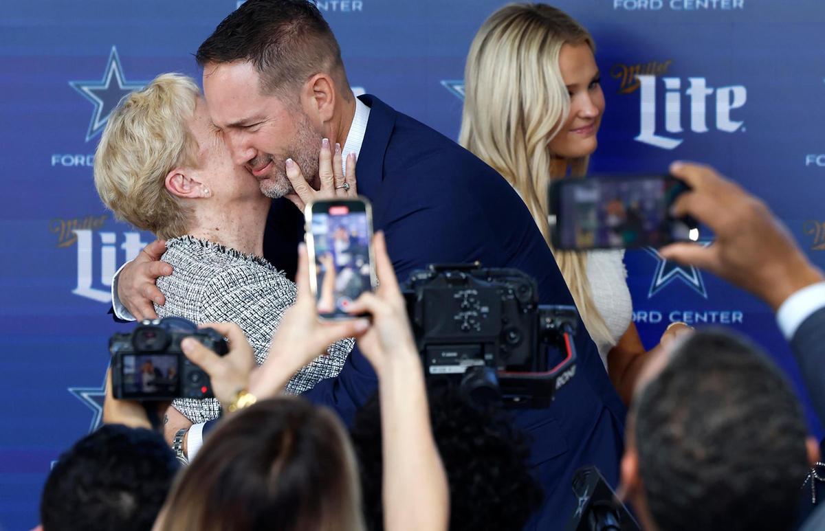 New Dallas Cowboys head coach Brian Schottenheimer, 10th Dallas Cowboys head coach in the franchise’s history, hugs his mother Pat following a press conference on Monday, Jan. 27, 2025, at The Star in Frisco.