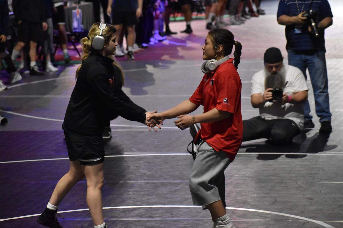 Arlington Martin wrestler Camille Rainey shakes an opponent's hand at the UIL Texas high school wrestling state tournament in Cypress, Texas, on Saturday, Feb. 14, 2026.
