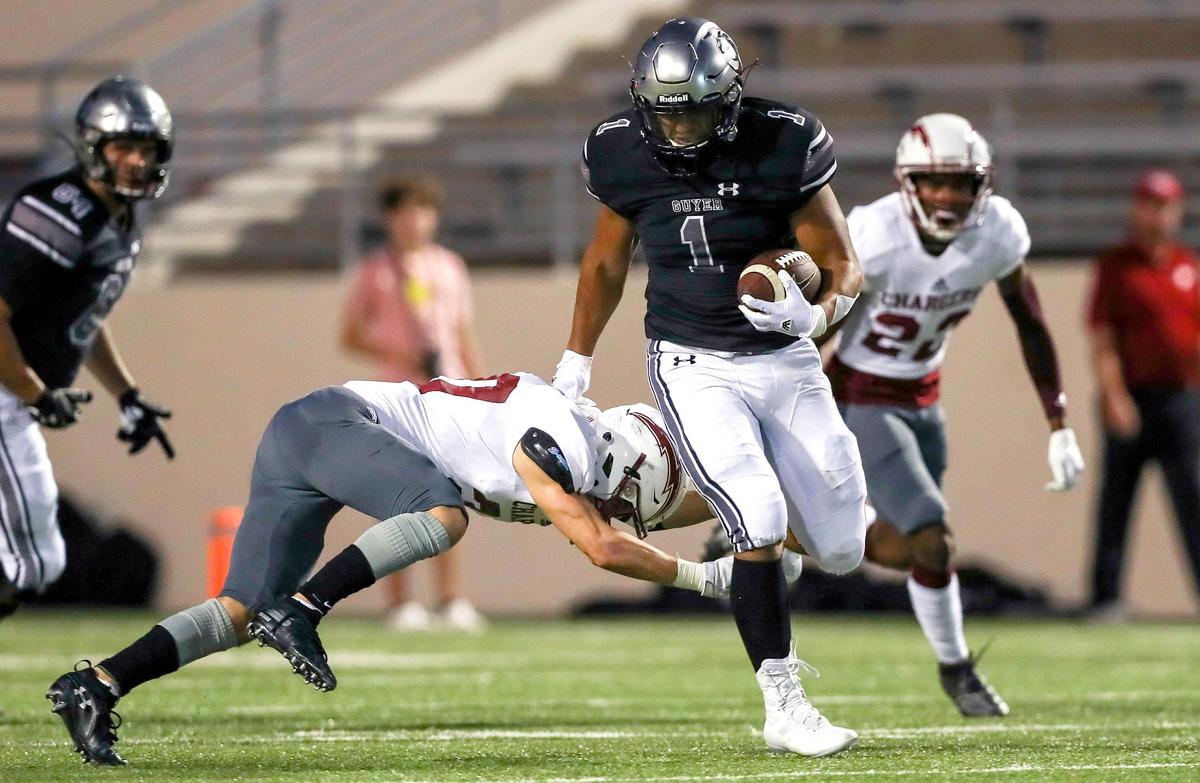 Denton Guyer running back Kaedric Cobbs (1) breaks a tackle from Keller Central defensive back Mitchell Dearing (20) during the first half, Thursday night, September 26, 2019 played at C.H. Collins Complex Stadium in Denton,