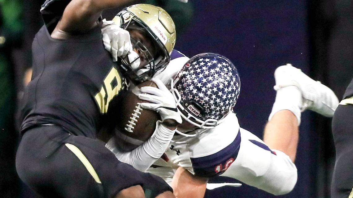 Birdville running back Laderrious Mixon (9) is brought down hard by Denton Ryan linebacker Drew Sanders (16) during the first half, Saturday night, December 8, 2018 in the 5A Division I quarterfinal playoff game played at the Ford Center in Frisco, TX.