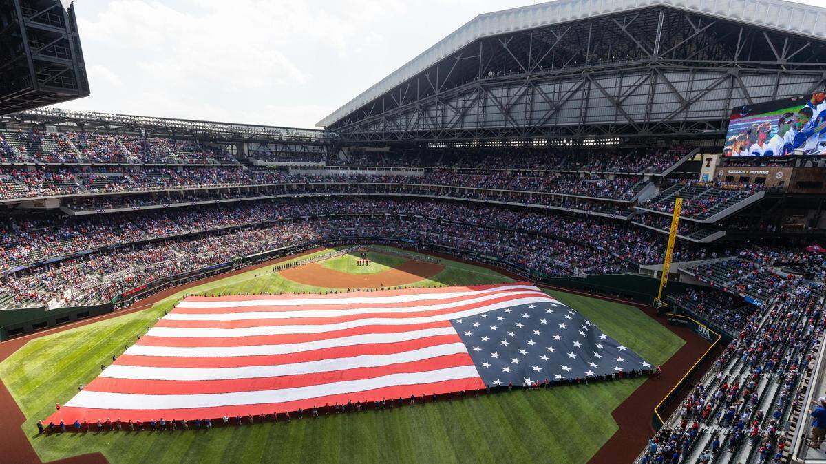 Fans fill the stands as the American Flag is opened on the field for the Texas Rangers opening day game Monday, April 11, 2022, at Globe Life Field in Arlington.