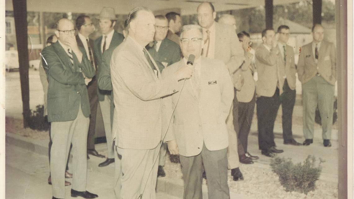 An announcer with KWBW asks Mayor Jim P. Martinez for comments in 1970 at the opening of Central State Bank in Hutchinson, Kansas.