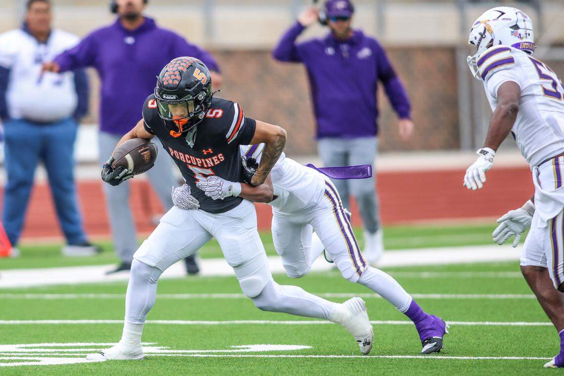 Springtown receiver Christian Mendoza (5) gets caught from behind by an Alvarado defender during a Class 4A Division I regional semifinal Friday, Nov. 28, 2025, at Knight Stadium at Eagle Mountain High School in Fort Worth.