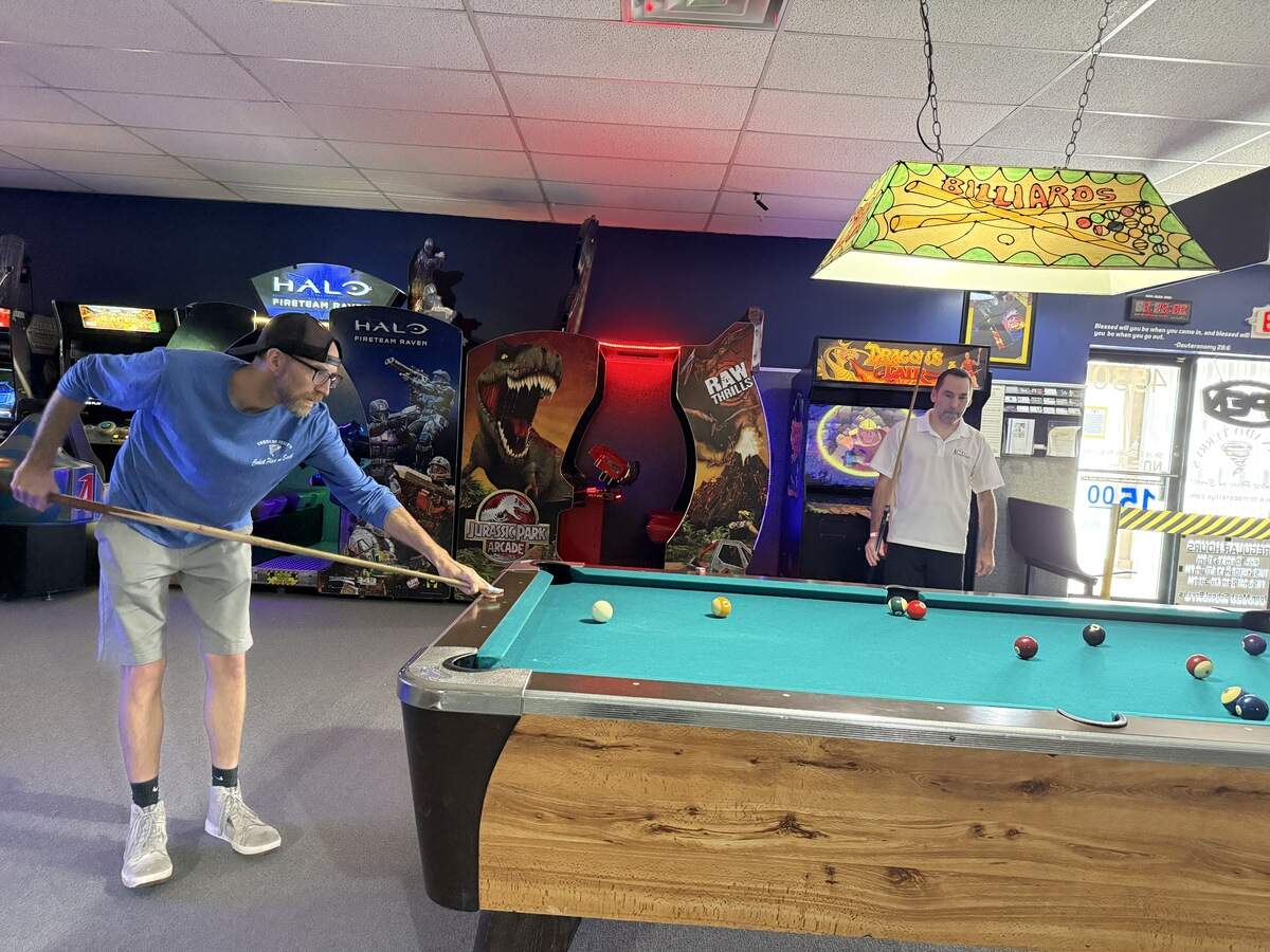 (Left)Richard Bell, the son of Terry Bell and longtime customer (right) Josh Moore play a game of pool in memory of the years they spent play and hanging out at Tornado Terry’s. The Fort Worth business plans on closing after 35-years on August 9, 2026.