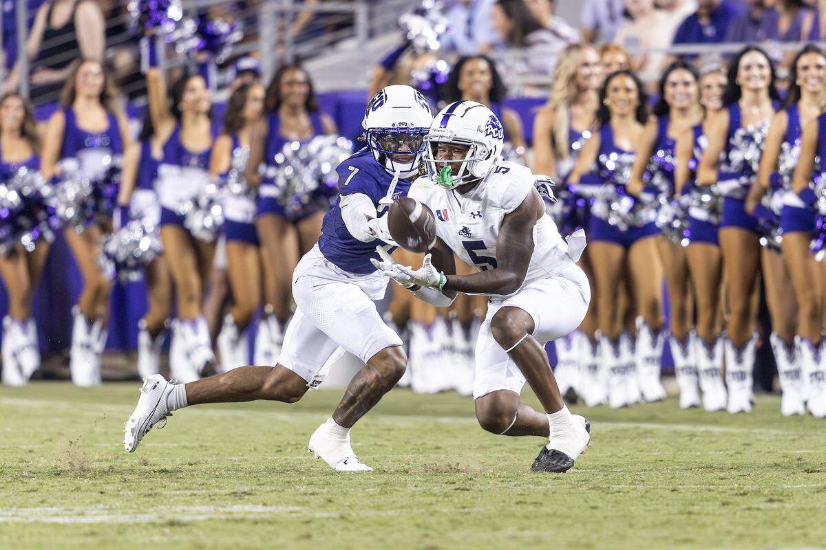 Abilene Christian wide receiver J.B. Mitchell III (5) catches a pass while defended by TCU cornerback Channing Canada (7) in the first half of an NCAA game between TCU and Abilene Christian at Amon G. Carter Stadium in Fort Worth on Saturday, Sept. 13, 2025.