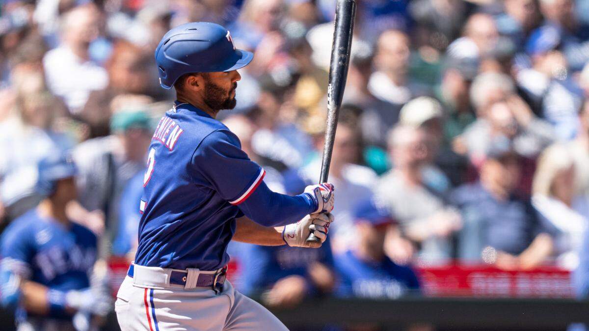Texas Rangers second baseman hits an RBI-single off Seattle Mariners relief pitcher Matt Brash (47) during the sixth inning at T-Mobile Park.