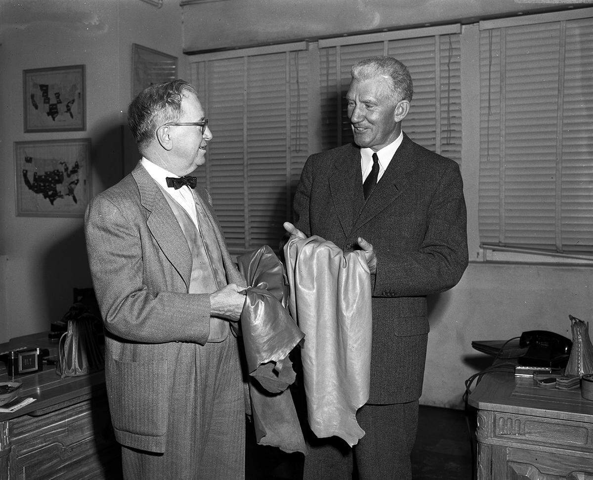 Oct. 24, 1953: Dave Tandy, left, and his visitor to Fort Worth, Lawrence L. Jones of Boston, representing the Tanners’ Council of America. The men are “examining the type of leather which fast is becoming a fashionable addition to the line of goods with which women bedeck themselves.”