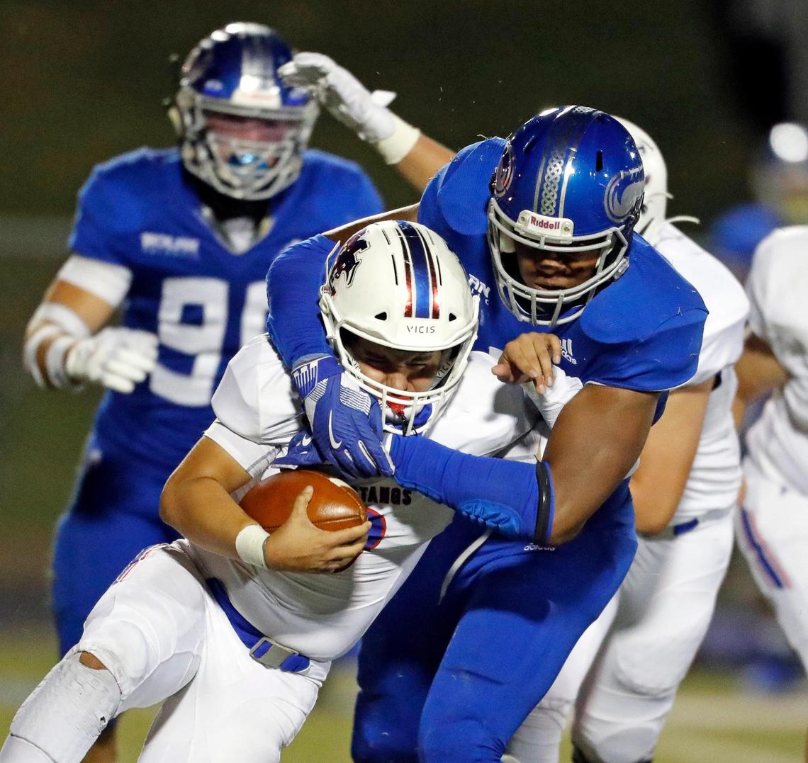 Midland Christian quarterback Ryver Rodriguez (3) is swallowed up in the backfield by Nolan Catholic defensive lineman Curlee Thomas (9) during a high school football game at Doskocil Stadium in Fort Worth, Texas, Friday, Oct. 02, 2020. Nolan Catholic defeated Midland Christian 38-21. (Special to the Star-Telegram Bob Booth)