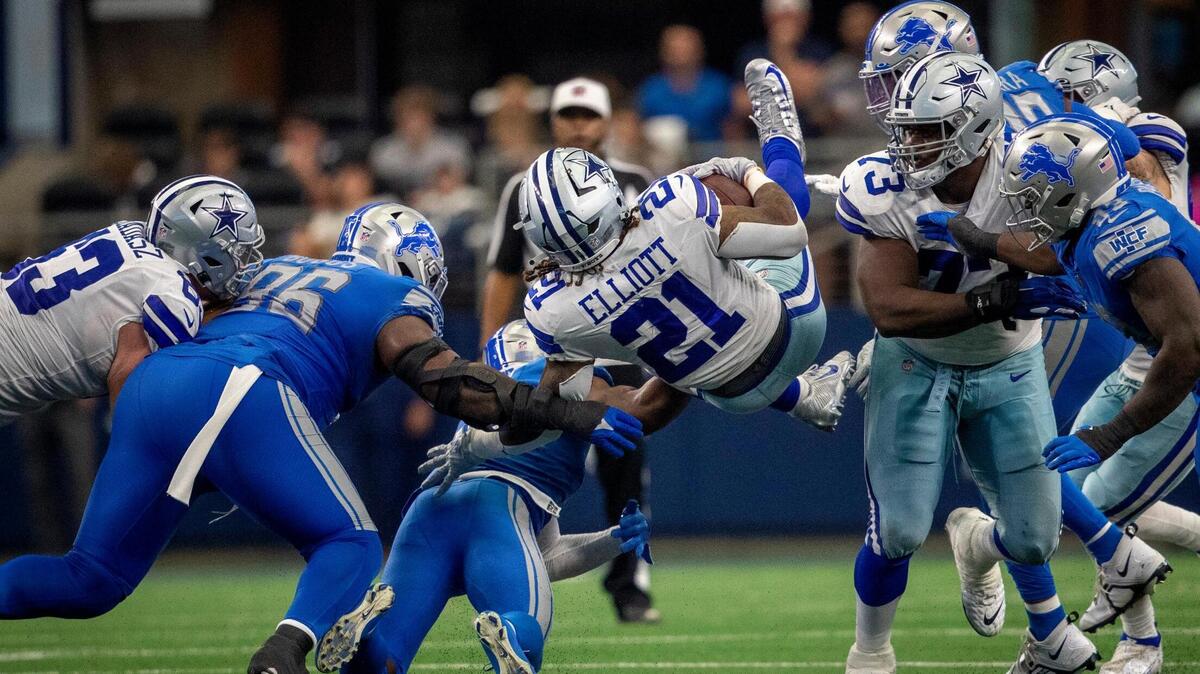 Dallas Cowboys running back Ezekiel Elliott flips over players to catch a pass during their game against the Detroit Lions at the AT&T Stadium in Arlington on Sunday, Oct. 23, 2022.