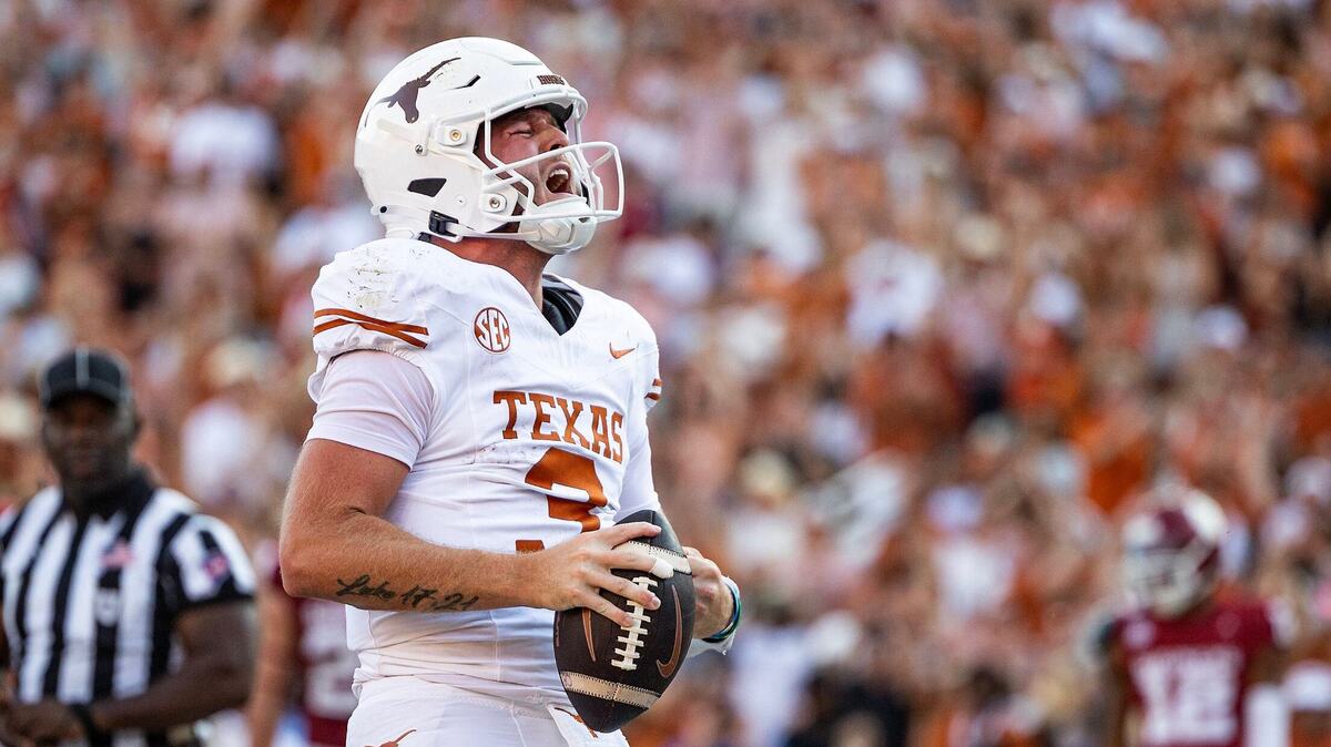 Texas quarterback Quinn Ewers celebrates after rushing for a touchdown in the second half of the Red River Rivalry game at the Cotton Bowl in Dallas on Saturday, Oct. 12, 2024.
