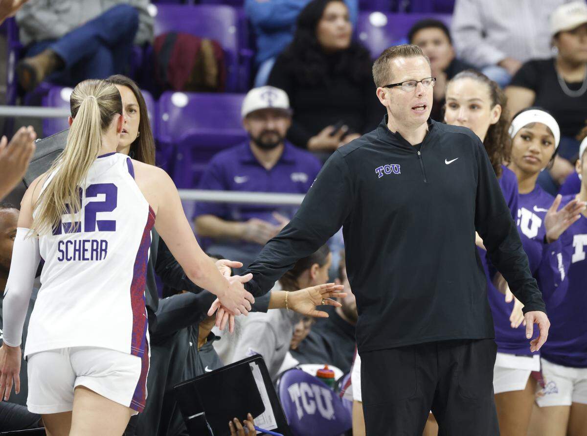 TCU head coach Mark Campbell welcomes guard Maddie Scherr (22) back to the bench during the first quarter of a NCAA women's basketball game between Tennessee State and TCU at Schollmaier Arena in Fort Worth, Texas, Wednesday Nov. 12, 2025.