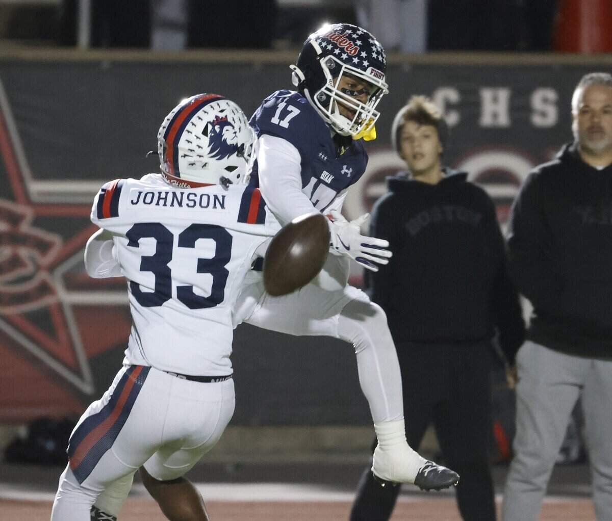 Denton Ryan wide receiver Brylon Moody (17) can not get a handle on the ball defended by Richland defensive back Bryson Johnson (33) during the first half of a UIL Class 5A Division I Regional on Friday Nov. 28, 2025 at Buddy Echols Field in Coppell, Texas.