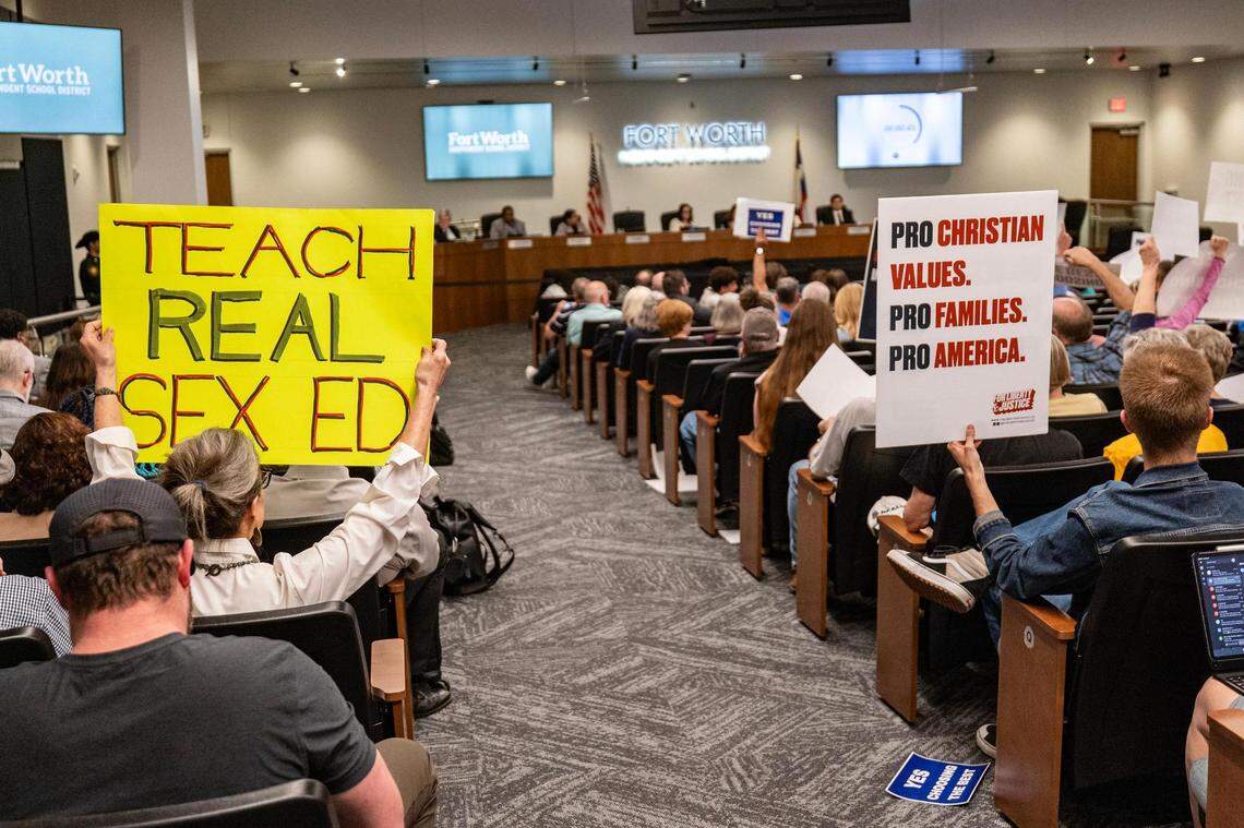 Supporters of the ‘HealthSmart’ curriculum and ‘Choosing The Best’ hold opposing signs next to each other at the Fort Worth ISD Administration Building on Tuesday, Feb. 27, 2024. The school board heard two hours of public comment on the future of sex education before voting on the curriculum.