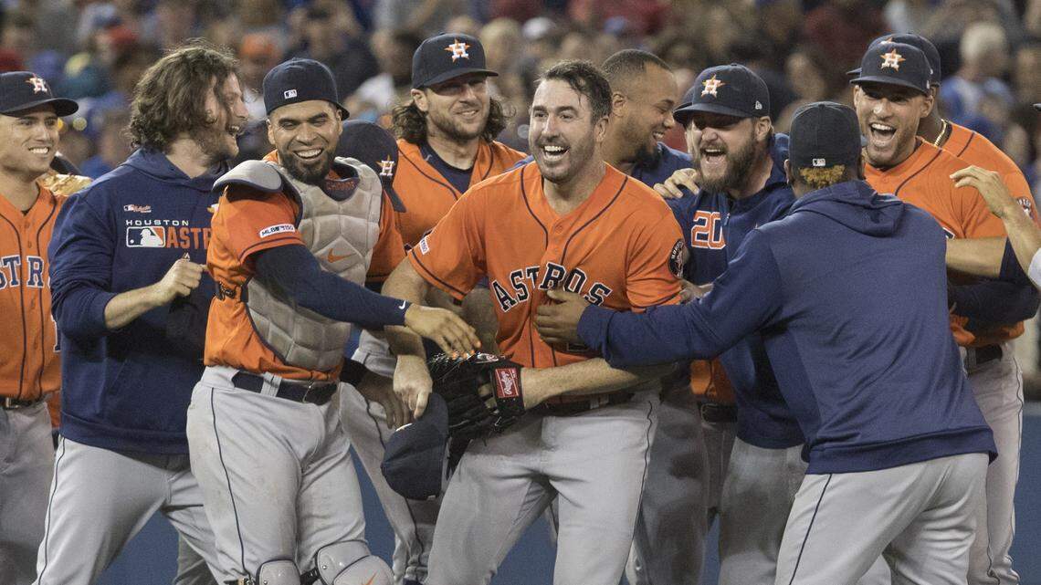 Houston Astros starting pitcher Justin Verlander, center, is mobbed by teammates Sunday after pitching a no-hitter against the Toronto Blue Jays at Rogers Centre. He’s the sixth pitcher to throw at least three no-hitters in his career.