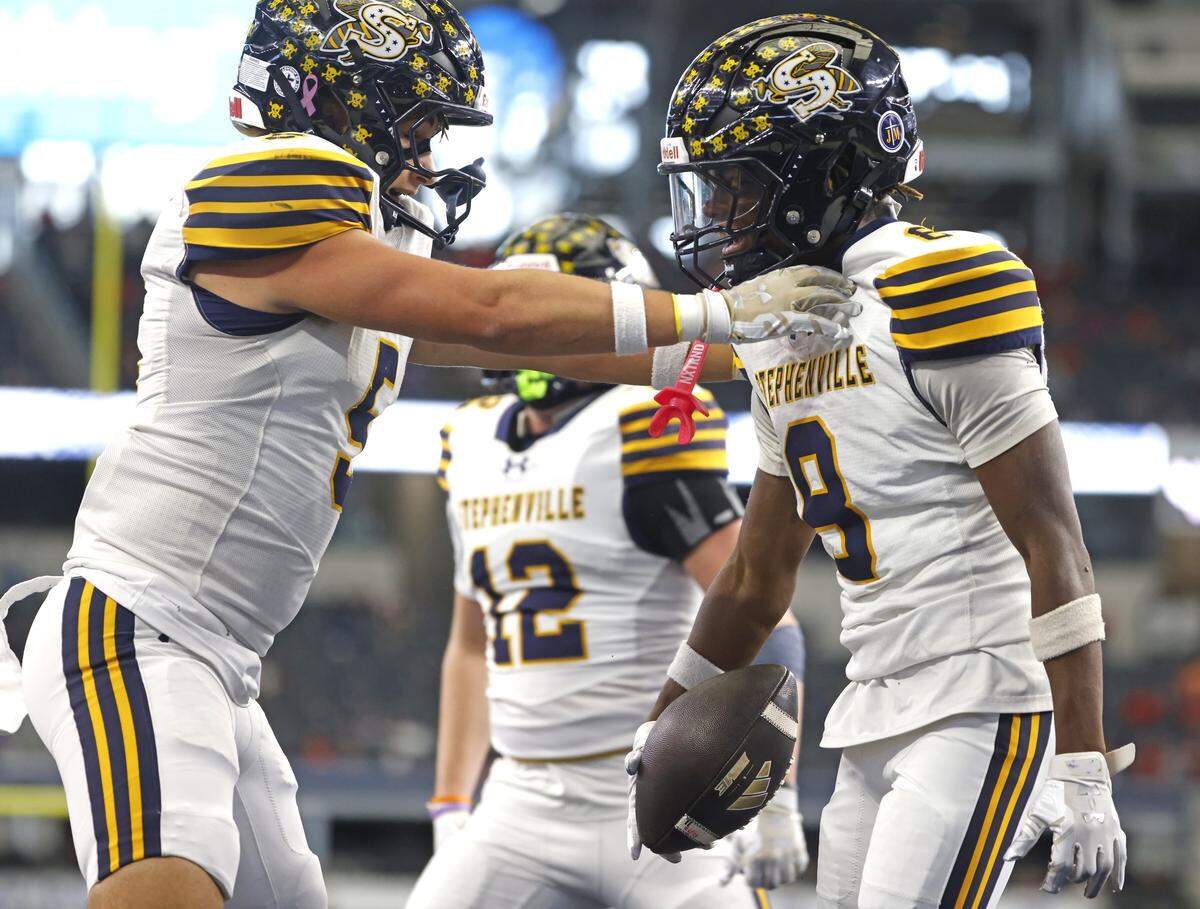 Stephenville defensive backs Cooper Fergason (5) and Willis Jackson (8) celebrate after Jackson intercepted Kilgore in the end zone during the first half of the UIL Class 4A Division I championship game on Friday Dec. 19, 2025 at AT&T Stadium in Arlington, Texas.