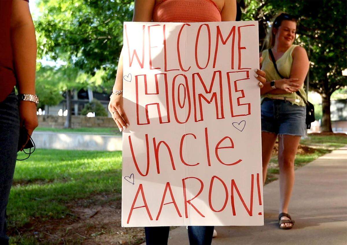 Friends and family of Aaron Dyson wait across the street from Tarrant County Corrections Center in downtown Fort Worth for his release on May 7, 2021. Dyson was released after spending 24 years in prison. Prosecutors at the time of his conviction charged him with engaging in organized crime and presented false evidence that Dyson was a member of the R-13 gang and that the shooting was gang related, which enhanced the charge and sentencing guidelines.
