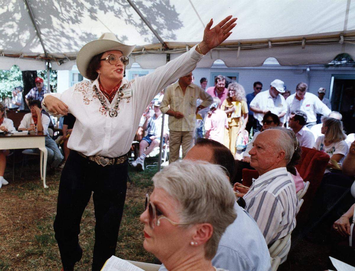 July 1990: Cookie Lockhart, of Auction Company of America, takes bids during liquidation of Nelson Bunker Hunt's assets at Circle T Ranch in Westlake. 