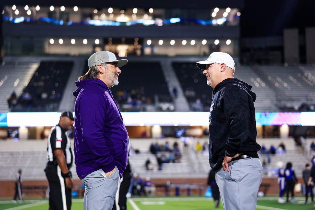 Alvarado head coach Casey Walraven (left) meets Sulphur Springs head coach Brandon Faircloth at midfield before their Class 4A Division I area playoff game Friday, Nov. 21, 2025, at Children's Health Stadium in Prosper, Texas.
