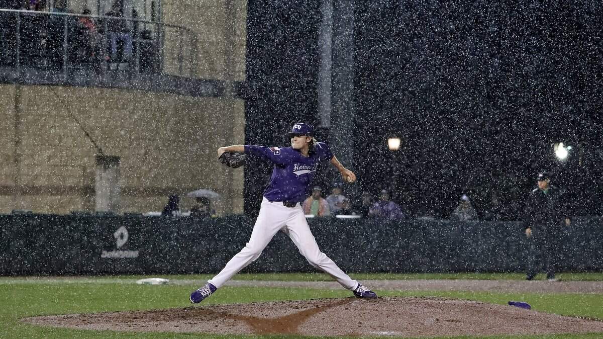 TCU starting pitcher Nick Lodolo delivers in the pouring rain, the last pitch before the game was suspended in the top of the third inning.