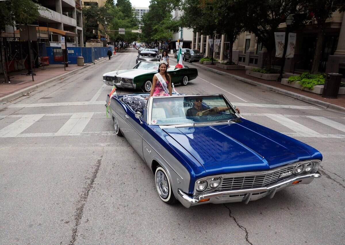 Sept. 10, 2016: Art Chavez of Fort Worth, in his lowered Chevy Impala, leads a line classic cars during the 16 de Septiembre Mexican Independence Day Parade in downtown.