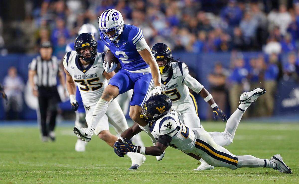 PROVO, UT - OCTOBER 3: Chase Roberts #2 of the Brigham Young Cougars is tackled by Darrian Lewis #24 of the West Virginia Mountaineers during the second half their game at LaVell Edwards Stadium on October 3, 2025 at Provo, Utah. (Photo by Chris Gardner/Getty Images)
