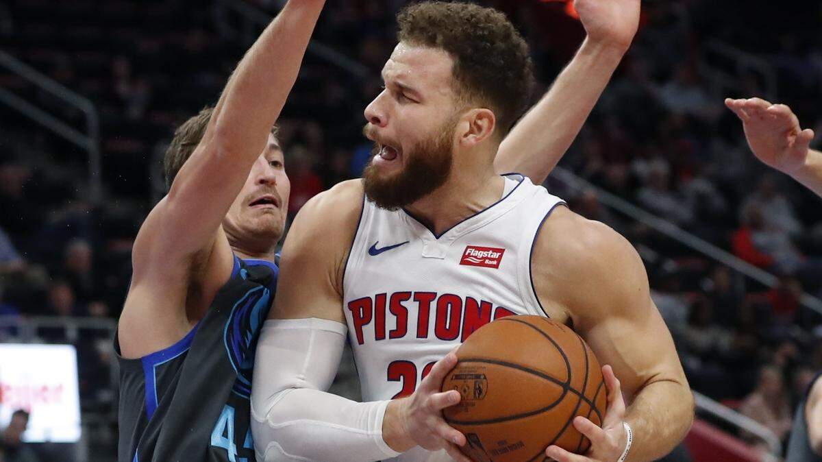 Detroit Pistons forward Blake Griffin (23) is defended by Dallas Mavericks guard Ryan Broekhoff (45) during the first half of an NBA basketball game Thursday, Jan. 31, 2019, in Detroit. (AP Photo/Carlos Osorio)