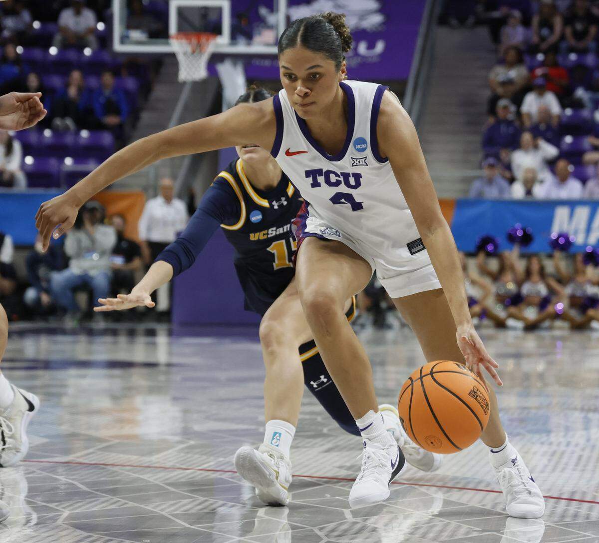 TCU guard Donovyn Hunter (4) brings the ball into the key ahead of UC San Diego guard Sabrina Ma (15) during the first half of an NCAA Division I Women's Basketball Championship game at Schollmeier Arena in Fort Worth, Texas, Friday, March, 20, 2026.