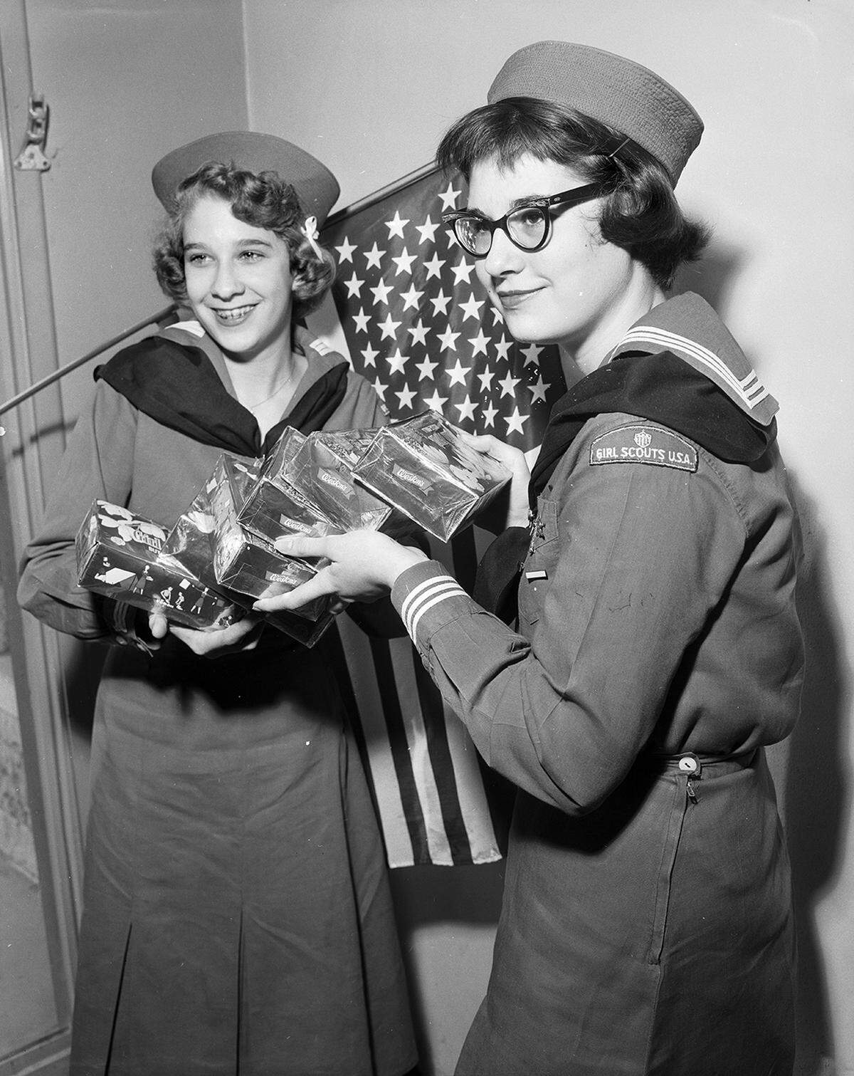 Feb. 17, 1959: The new 49-star flag of the United States will be given each Girl Scout troop selling an average of 36 boxes of cookies per girl. With a new flag are Mariners Pat Cole, left, and Margwen Murphy of Ship 7. Proceeds of the cookie sale, now under way, go to the organization’s camping activities.