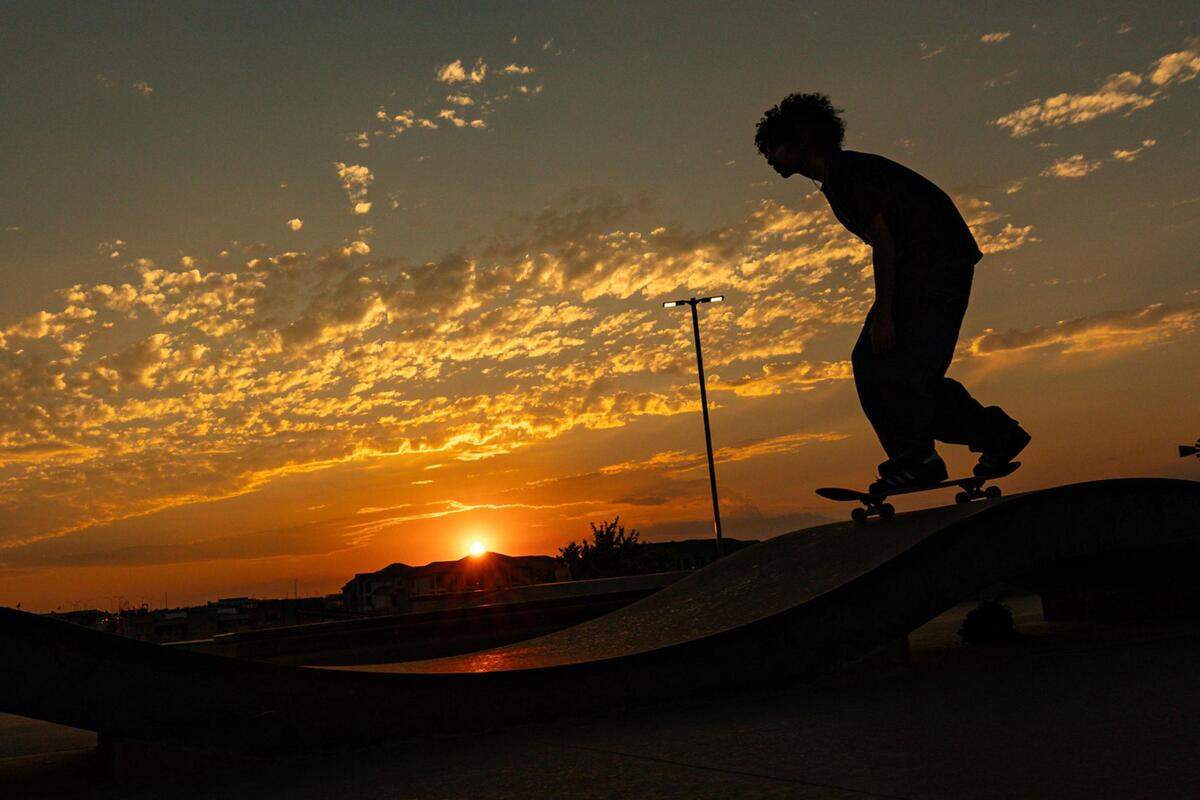 Ramsey Rivera skates up a slope at sunset at Chisholm Trail Skate Park in Fort Worth on Tuesday, Aug. 29, 2023.