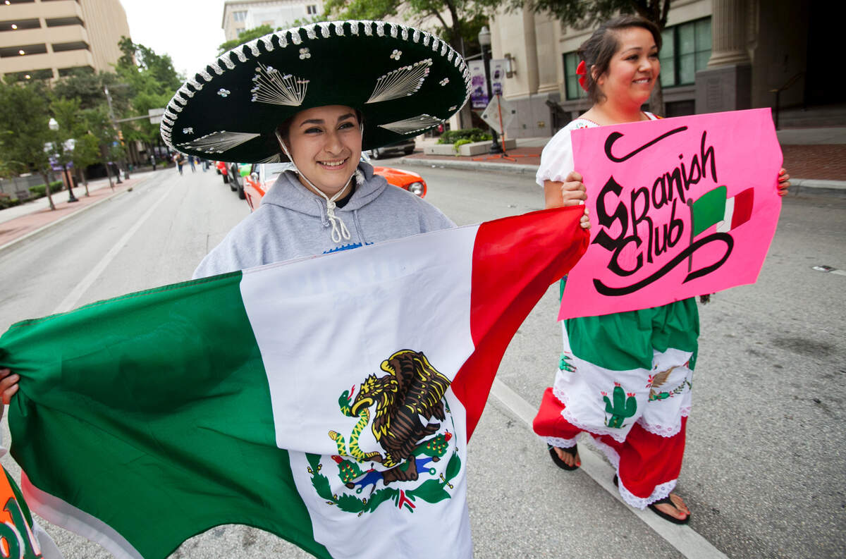 Sept. 13, 2014: Samantha Alfaro, middle, and Genesis Ortiz are members of Trimble Tech’s Spanish Club. They march with hundreds of other participants through the streets of downtown Fort Worth during the annual Mexican Independence Day Parade.