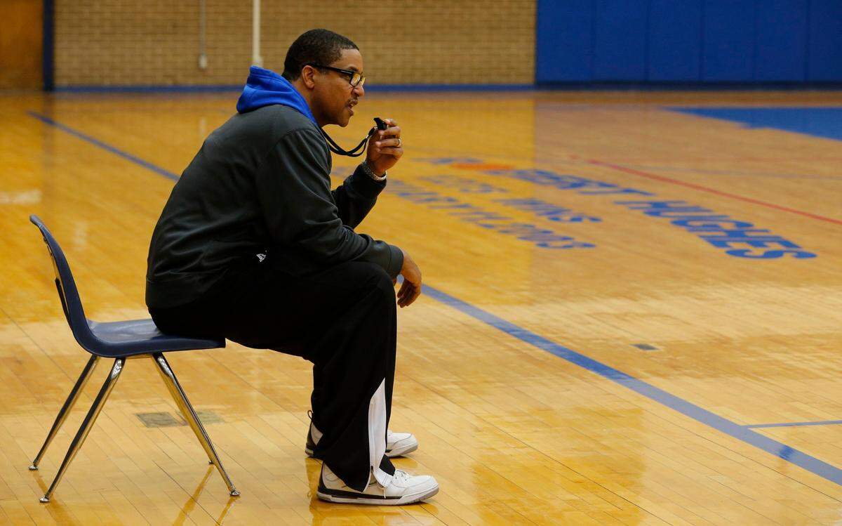 Coach Robert Hughes Jr. watches his players during Dunbar High School basketball practice, Tuesday, March 8, 2016.