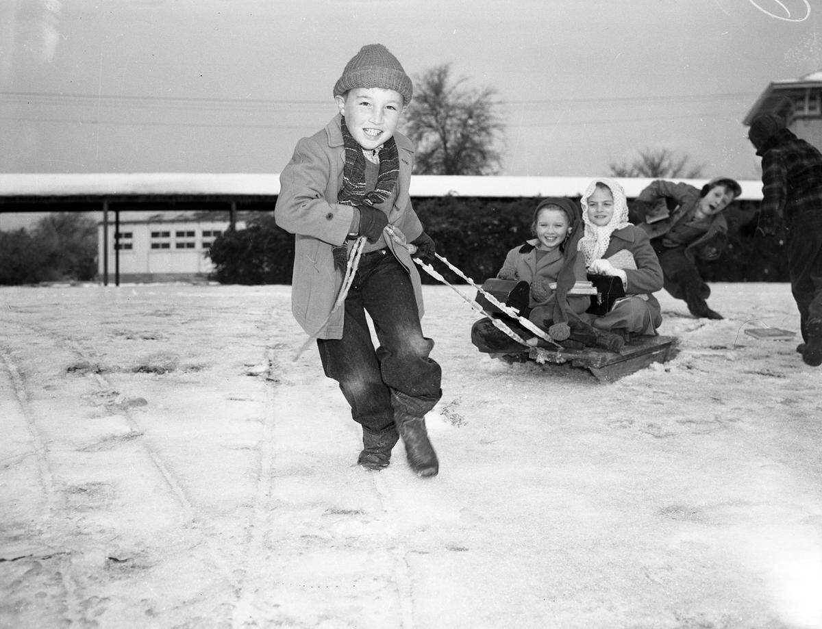 Jan. 2, 1947: “Jimmy Elder pulling a snow sled holding Patricia Newland (front) and Emmalene Bohannon.”