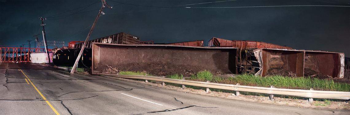 Fort Worth firefighters work in front of derailed train cars early Wednesday morning.