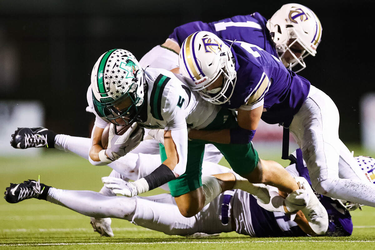 Southlake Carroll wide receiver Blake Gunter (5) is tackled by a host of Keller Timber Creek defenders during a district matchup on Thursday, September 25, 2025 at Keller ISD Stadium in Keller, Texas.