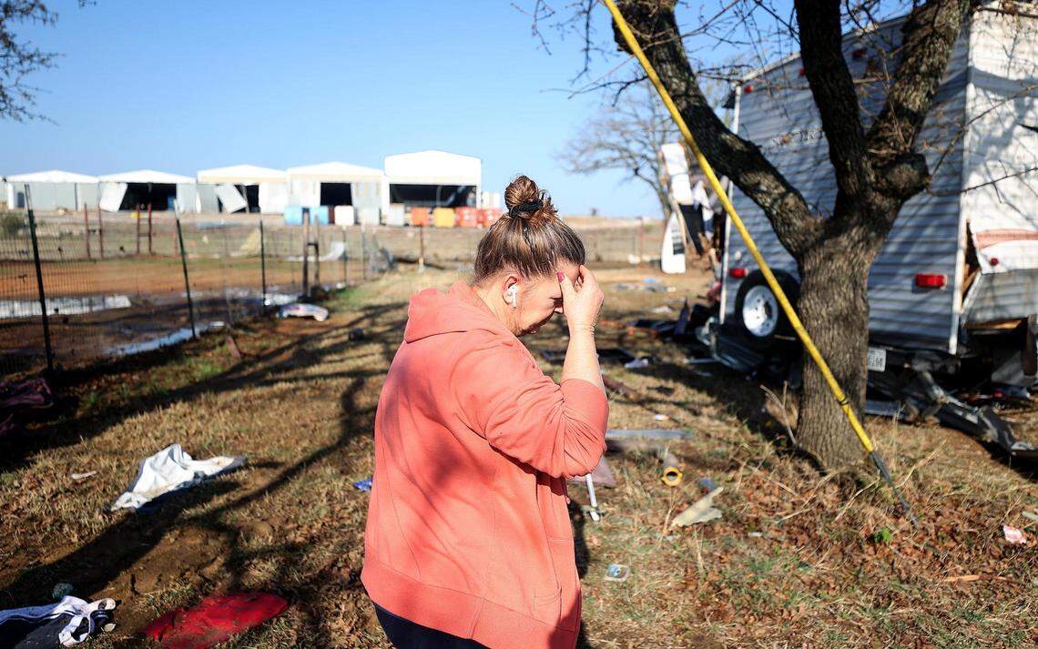 Amber Zeleny talks on the phone with her insurance agent on April 5 after a tornado damaged her Johnson County home and injured her husband.