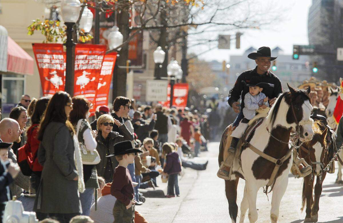 Jan. 14, 2012: Jose Morales and his 2-year-old son, Miguel, ride with La Guadalupana riding club in the Fort Worth Stock Show and Rodeo All Western Parade in downtown.