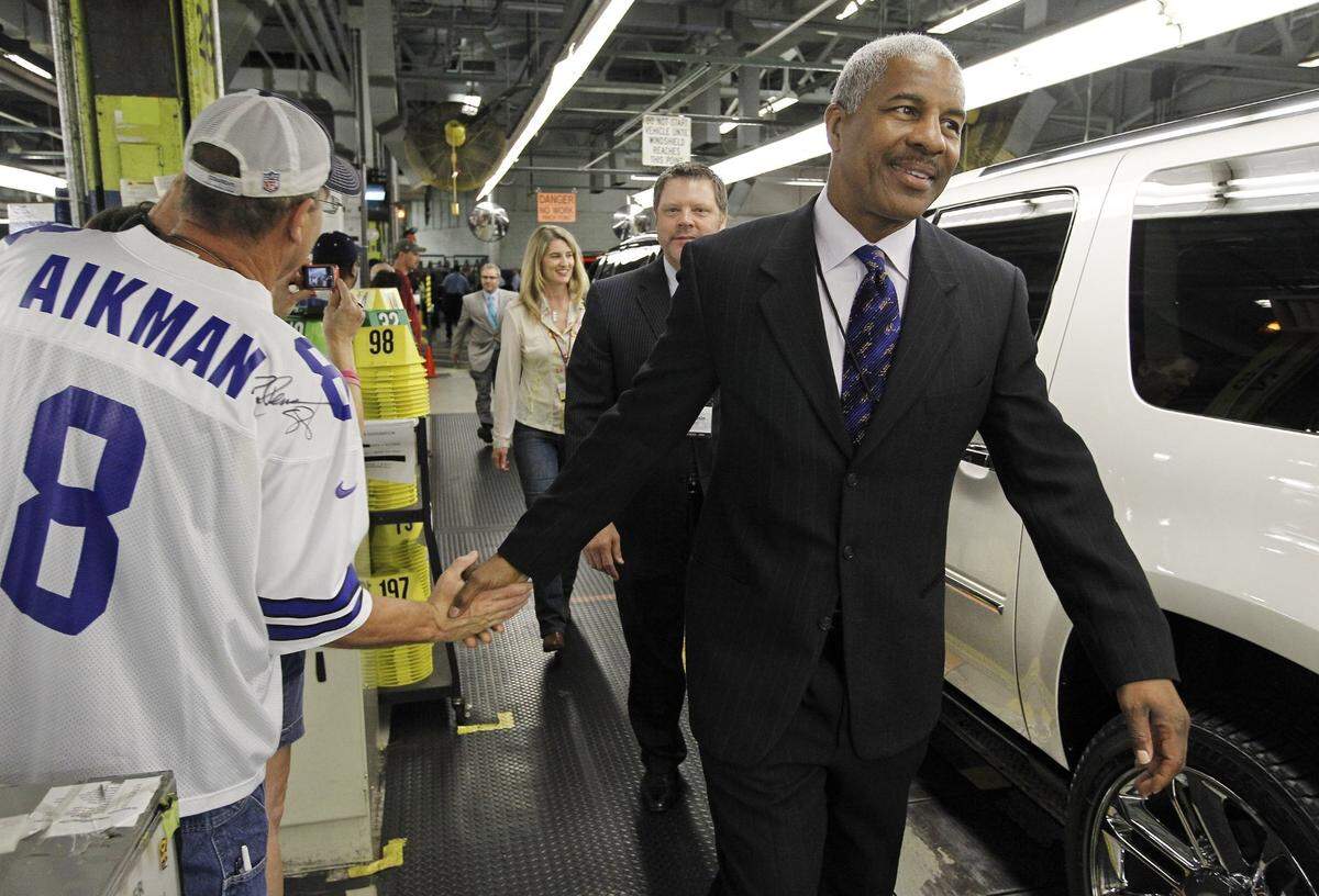 Sept. 22, 2011: General Motors employee Jack Hargrove, left, shakes hands with former Cowboys player Everson Walls as he walks to a Cadillac Escalade at the Arlington plant. GM rolled out its big SUVs carrying local celebrities to draw attention to six local charities.