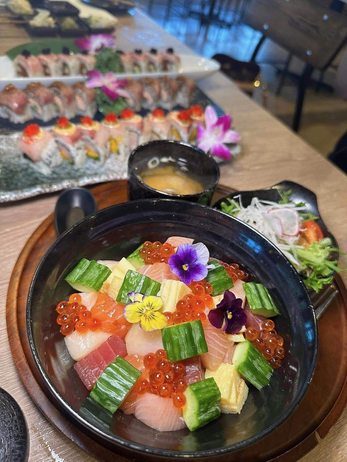 Salmon, tuna and yellowtail sashimi over sushi rice with cucumber, tamago and ikura.