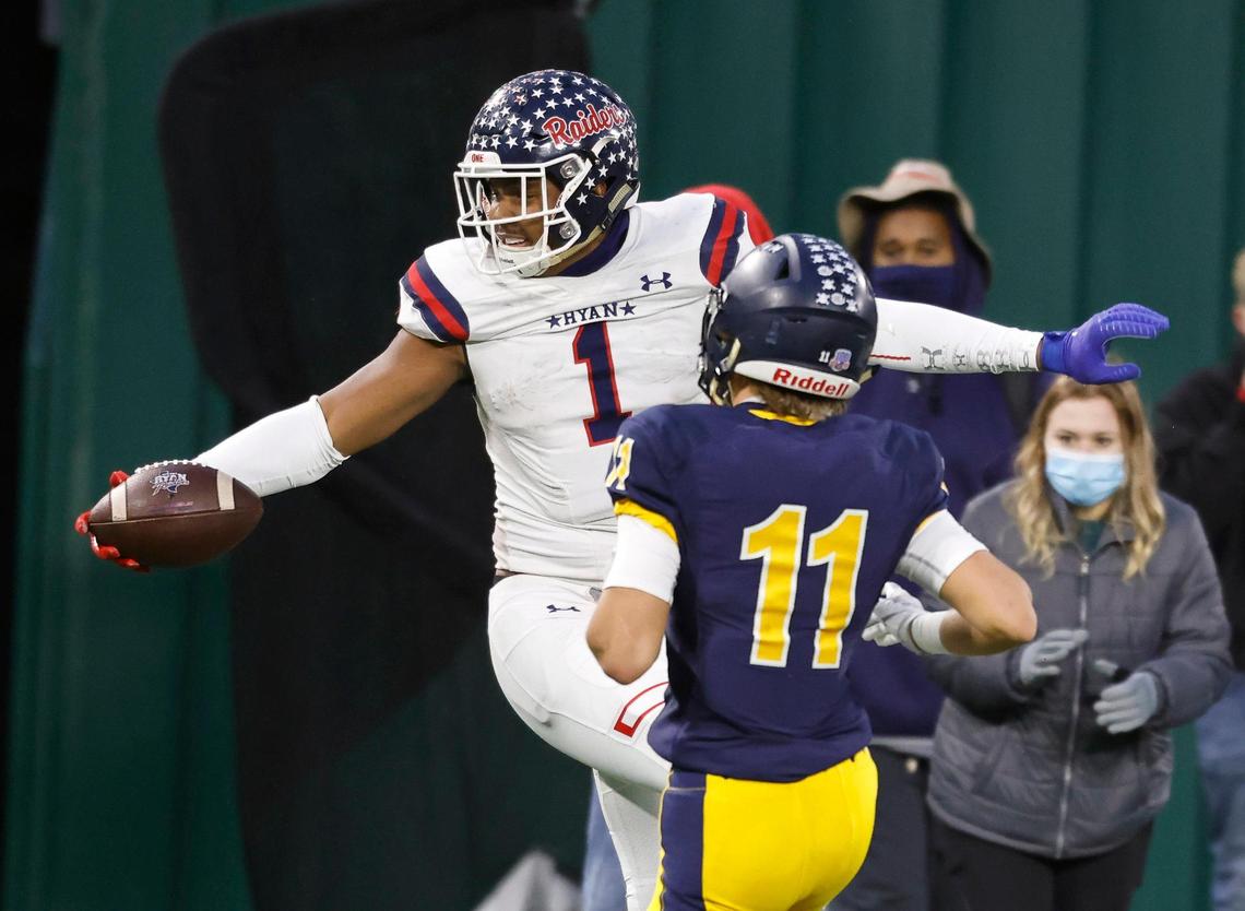 Denton Ryan wide receiver Ja’Tavion Sanders (1) twists toward the end zone defended by Highland Park defensive back Garrison Vincent during the 5A division 1 quarterfinals at Globe Life Park in Arlington, Texas, Friday, Jan. 01 2021. After a scoreless second half Denton Ryan defeated Highland Park 17-7. (Special to the Star-Telegram Bob Booth)