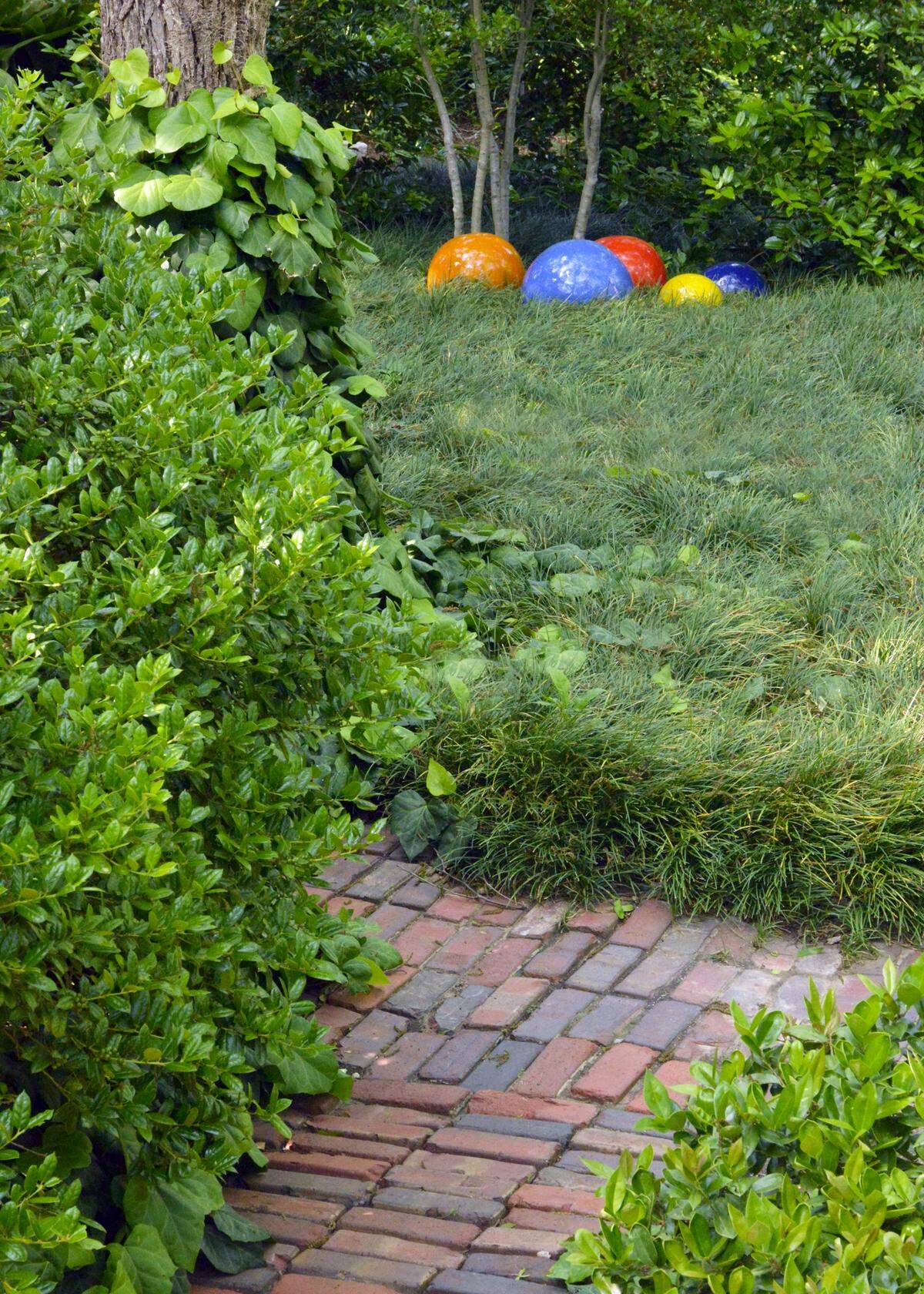 Antique street pavers complement modern globes where you need color in shade.