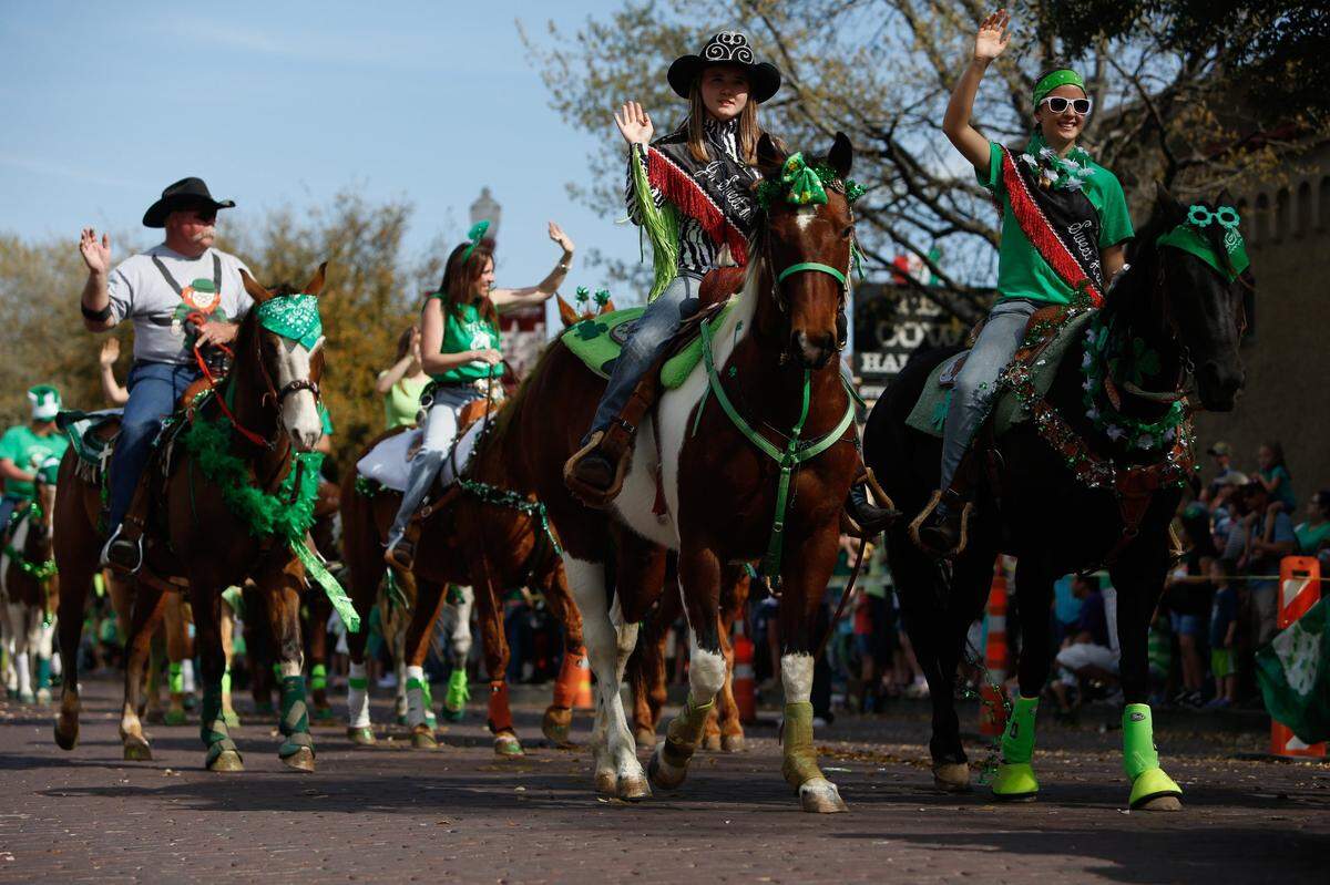 March 16, 2013: Horseback riders wave to the crowd during the St. Patrick’s Day Parade at the Fort Worth Stockyards.