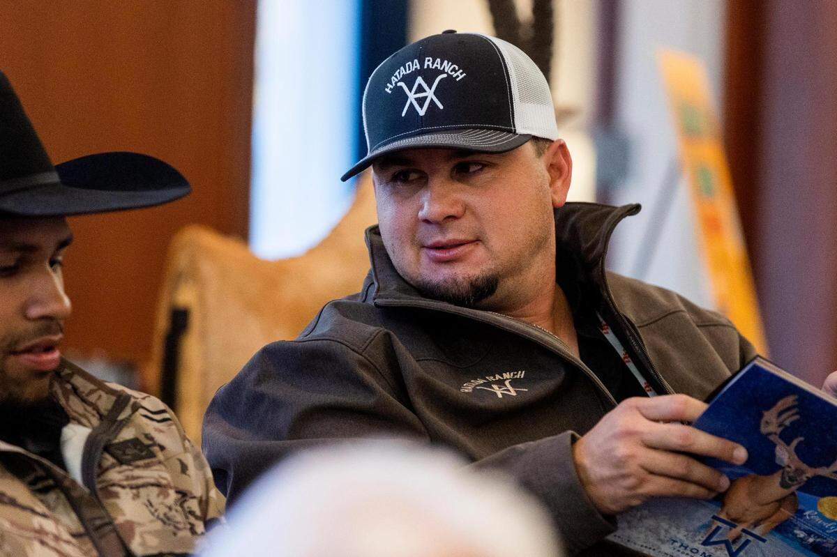 Catlin Dutschmann, the ranch manager of whitetails at Hatada Ranch, looks over the auction book during the Deer Breeding Corp.’s January 2022 auction at Horseshoe Bay Resort.