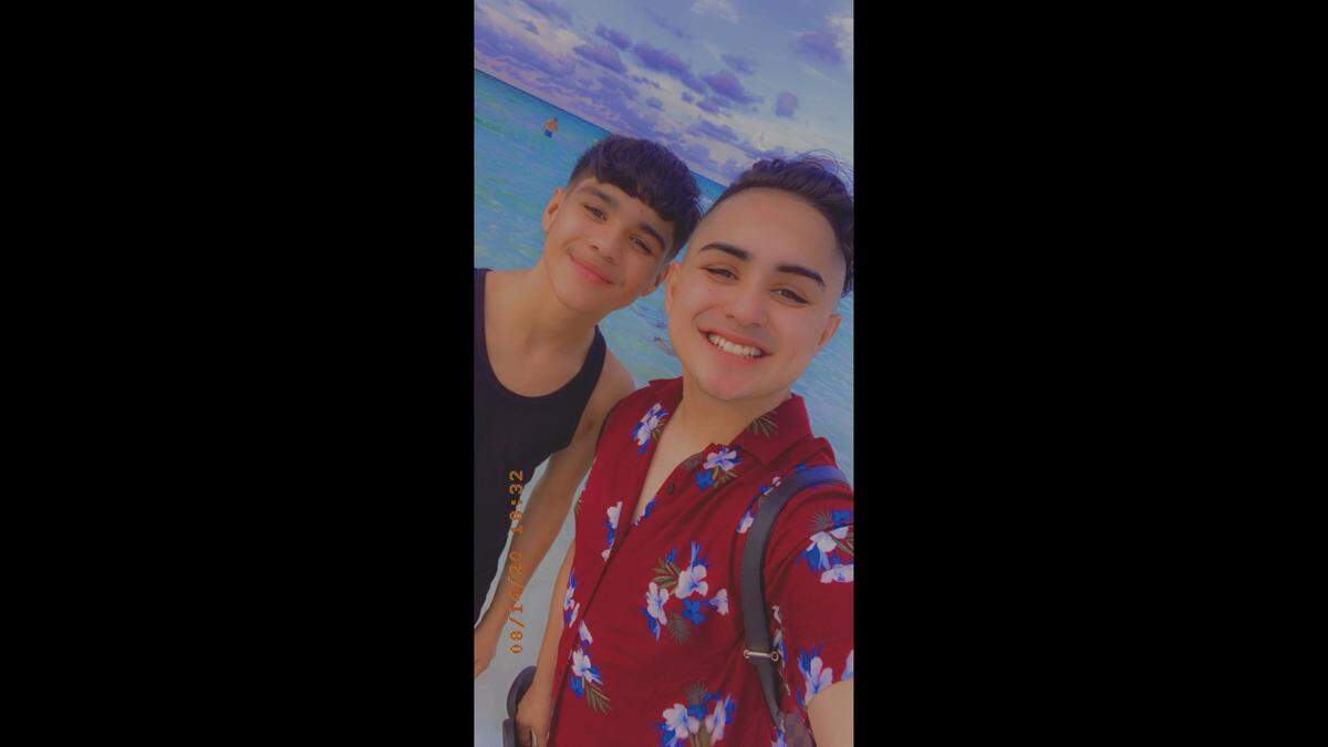 Emiliano Serna, left, is pictured with his brother Oliver, right, posing in a selfie on the beach.