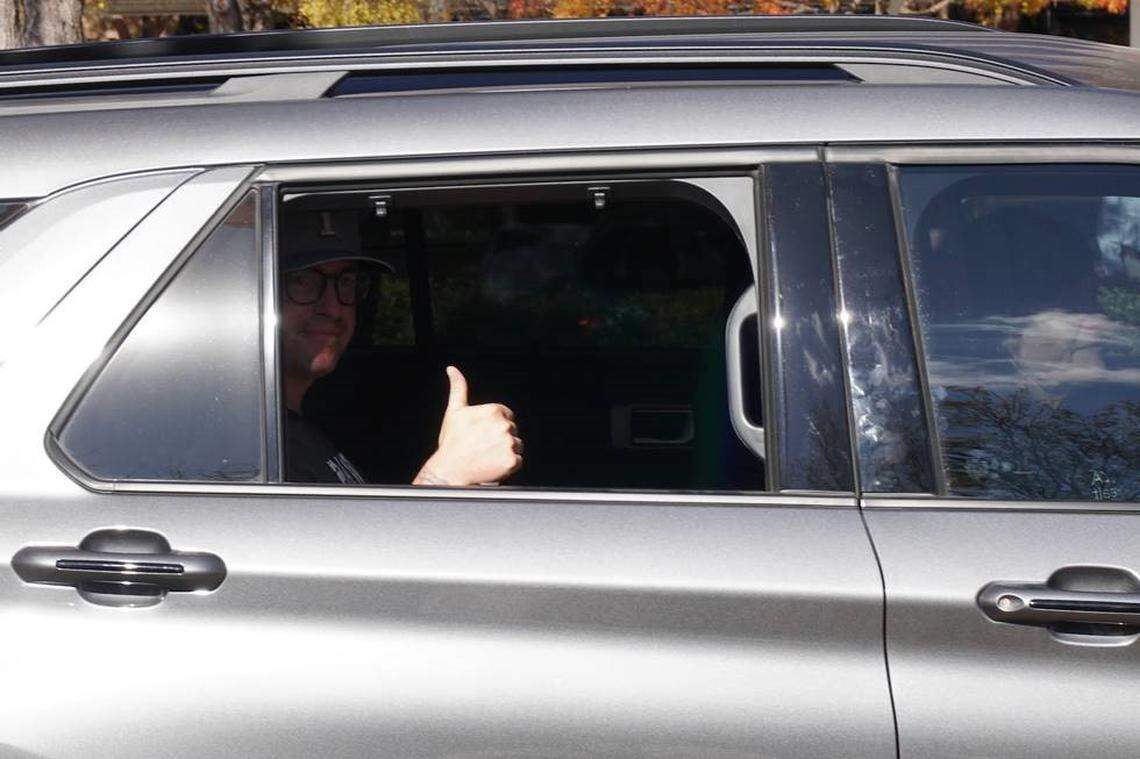 Tarrant County Sheriff’s Deputy Brent Brown gives a thumbs up as he is driven away from JPS Hospital on Friday, Dec. 8, 2023.