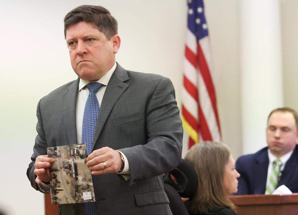Assistant Tarrant County Criminal District Attorney Dale Smith shows the jury evidence while cross-examining Aaron Dean on Monday, December 12, 2022, in Fort Worth. Dean, a former Fort Worth police officer, fatally shot Atatiana Jefferson in 2019 through a window at her home.