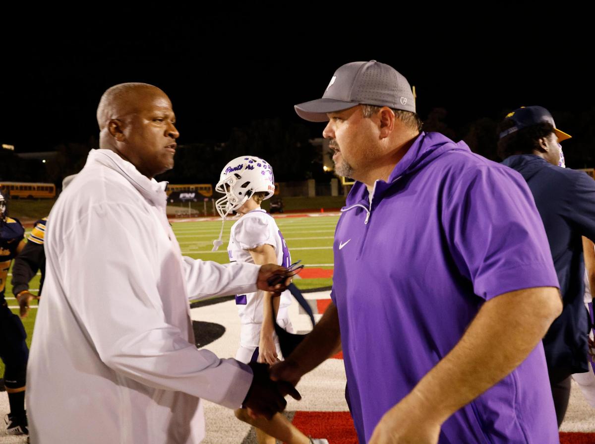 Arlington Heights head coach Curtis James and Paschal head coach John Killough meet in the middle of the field after the Battle of the Bonfire UIL District 4-5A D1 football game at Farrington Field in Fort Worth, Texas, Friday, Nov. 08, 2024.