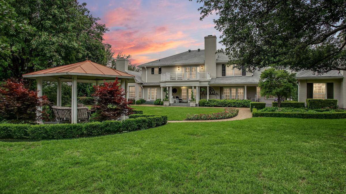The home at 6158 Indian Creek Drive is situated up high on lushly landscaped grounds.